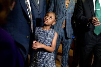 Gianna Floyd, George Floyd's daughter, looks on as Philonise Floyd, George Floyd's brother, and Ben Crump, attorney representing George Floyd's family, speak to members of the media in Washington, D.C., U.S., on Tuesday, May 25, 2021. President Biden met with members of George Floyd's family on the anniversary of his killing by a Minneapolis police officer as negotiations on Capitol Hill to overhaul law enforcement slipped past the White House's deadline. Photographer: Stefani Reynolds/Bloomberg via Getty Images