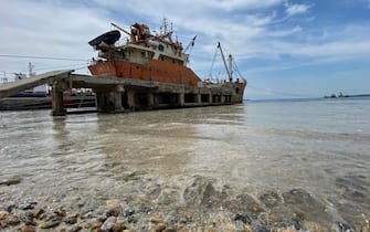 epa09247092 A ship waits at the coast of the Marmara sea covered by sea snot in Istanbul, Turkey, 04 June 2021. Because of global heating, blanket of mucus-like substance in Marmara sea increasing day by day threatens fishing industry and the environment. Sea snot is formed as a result of the proliferation of microalgae called phytoplankton in the sea. The biggest reason for this is that the water temperature in the Marmara sea is 2.5 degrees above the average of the last 40 years.  EPA/ERDEM SAHIN