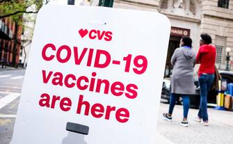 People walk past a sign for COVID-19 vaccines outside of a CVS pharmacy, one of two national pharmacy chains providing vaccination shots around the country, in the Brooklyn borough of New York, New York, USA, 03 May 2021. ANSA/JUSTIN LANE