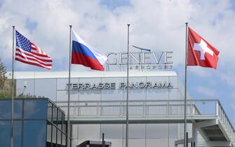 epa09273061 Flags of the US, Russia and Switzerland fly at Cointrin airport ahead of a meeting between US President Joe Biden and his Russian counterpart Vladimir Putin, in Geneva, Switzerland, 15 June 2021. The meeting between US President Joe Biden and Russian President Vladimir Putin is scheduled in Geneva for 16 June 2021.  EPA/DENIS BALIBOUSE / POOL