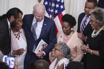 Opal Lee, an activist known as the grandmother of Juneteenth, center, speaks with U.S. President Joe Biden, center left, during a signing ceremony for the Juneteenth National Independence Day Act in the East Room of the White House in Washington, D.C., U.S., on Thursday, June 17, 2021. Biden signed the legislation that will make June 19 a federal holiday commemorating the end of slavery in the United States after the House and Senate passed the bill in votes earlier this week. Photographer: Oliver Contreras/Sipa/Bloomberg via Getty Images