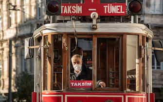 November 28, 2020, Istanbul, Turkey: A driver of the historical tram wearing a face mask as a precaution against the spread of covid-19 driving along Isttiklal Street near Taksim. (Credit Image: © John Wreford/SOPA Images via ZUMA Wire)