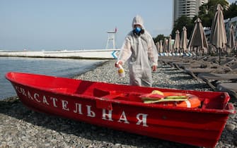 SOCHI, RUSSIA – JUNE 22, 2021: An employee in a protective suit disinfects a rescue boat on the Primorsky beach by the Black Sea amid the ongoing novel coronavirus pandemic. Dmitry Feoktistov/TASS/Sipa USA
