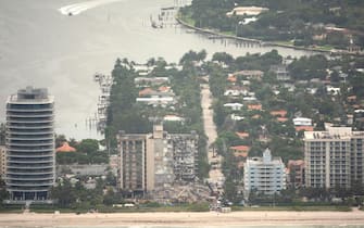 epa09304571 An aerial view of the partial collapsed 12-story condominium building in Surfside, Florida, USA, 26 June 2021. Miami-Dade Fire Rescue officials said more than 80 units responded to the collapse at the condominium building near 88th Street and Collins Avenue just north of Miami Beach on last 24 June around at 2 a.m.  EPA/CRISTOBAL HERRERA-ULASHKEVICH