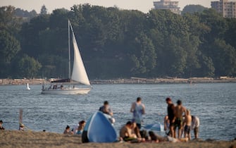A sailboat passes English Bay Beach during a heatwave in Vancouver, British Columbia, Canada, on Monday, June 28, 2021. The heat is expected to continue for several days in some parts of British Columbia, according to weather warnings from the government. Photographer: Trevor Hagan/Bloomberg
