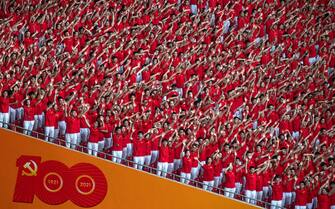 BEIJING, CHINA - JUNE 28: Members of the audience wave during a mass gala marking the 100th anniversary of the Communist Party on June 28, 2021 at the Olympic Bird's Nest stadium in Beijing, China. China will officially mark the 100th anniversary of the founding of the Communist Party on July 1st. (Photo by Kevin Frayer/Getty Images)