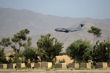 TOPSHOT - A US Air Force transport plane lands at the Bagram Air Base in Bagram on July 1, 2021. (Photo by WAKIL KOHSAR / AFP) (Photo by WAKIL KOHSAR/AFP via Getty Images)