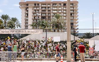 SURFSIDE, FLORIDA - JULY 02: A general view of a memorial that has pictures of some of the missing from the partially collapsed 12-story Champlain Towers South condo building on July 02, 2021 in Surfside, Florida. The pictures were placed on the fence as loved ones try to find them. Over one hundred people are being reported missing as the search-and-rescue effort continues.   (Photo by Michael Reaves/Getty Images)