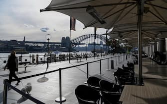 epa09330732 Empty tables and chairs are seen at a closed restaurant along a quiet Circular Quay in Sydney, Australia, 08 July 2021. NSW has recorded 38 new locally acquired COVID-19 cases overnight, the highest daily number of new cases in 14 months.  EPA/BIANCA DE MARCHI AUSTRALIA AND NEW ZEALAND OUT