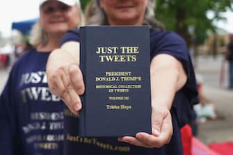 TULSA, OK - JUNE 20: A woman holds a book of compiled tweets of President Donald Trump prior to a campaign rally for President Donald Trump at the BOK Center on June 20, 2020 in Tulsa, Oklahoma. Trump is scheduled to hold his first political rally since the start of the coronavirus pandemic at the BOK Center on Saturday while infection rates in the state of Oklahoma continue to rise. (Photo by Michael B. Thomas/Getty Images)