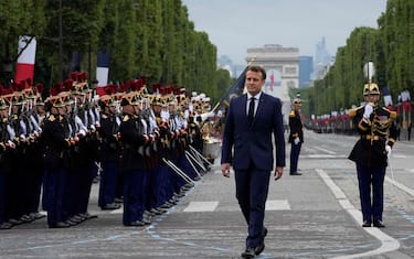 France's President Emmanuel Macron walks past members of The Republican Guard as he reviews the troops during the annual Bastille Day military parade on the Champs-Elysees avenue in Paris on July 14, 2021. (Photo by Michel Euler / POOL / AFP) (Photo by MICHEL EULER/POOL/AFP via Getty Images)