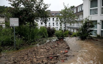 epa09343912 A flooded backyard of an evacuated retirement home as heavy rain hits Hagen, Germany, 14 July 2021. Large parts of North Rhine-Westphalia were hit by heavy, continuous rain Tuesday evening. According to the German Weather Service (DWD), the rain is not expected to let up until 15 July. The Rhine level has risen significantly in recent days.  EPA/FRIEDEMANN VOGEL