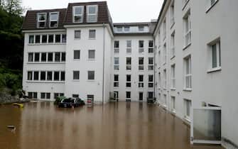 epa09343908 A flooded courtyard of an evacuated retirement home as heavy rain hits Hagen, Germany, 14 July 2021. Large parts of North Rhine-Westphalia were hit by heavy, continuous rain Tuesday evening. According to the German Weather Service (DWD), the rain is not expected to let up until 15 July. The Rhine level has risen significantly in recent days.  EPA/FRIEDEMANN VOGEL