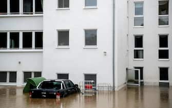 epa09343910 A flooded courtyard of an evacuated retirement home as heavy rain hits Hagen, Germany, 14 July 2021. Large parts of North Rhine-Westphalia were hit by heavy, continuous rain Tuesday evening. According to the German Weather Service (DWD), the rain is not expected to let up until 15 July. The Rhine level has risen significantly in recent days.  EPA/FRIEDEMANN VOGEL