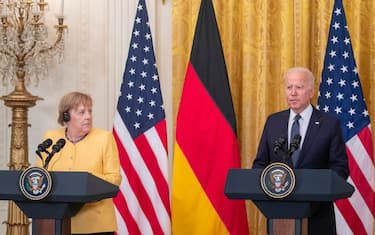 epa09347357 US President Joe Biden and German Chancellor Angela Merkel participate in a joint press conference in the East Room of the White House in Washington, DC, USA, 15 July 2021. The two leaders met earlier to discuss the Russian Nord Stream 2 pipeline, climate change, Covid-19 vaccines, and Russian cyber attacks.  EPA/SHAWN THEW