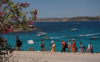 COMINO, MALTA - [11th July 2021]: Tourists walk towards Blue Lagoon on July 11, 2021 in Comino, Malta. Malta, Europe's smallest nation, is now on The Uk's green list for travel. (Photo by Joanna Demarco/Getty Images)
