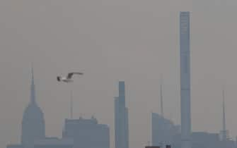 epa09357254 Smoke from western wildfires obscures the view looking towards Manhattan from Yankee Stadium before the start of the Philadelphia Phillies and New York Yankees, Major League Baseball (MLB) game at Yankee Stadium in the Bronx, New York, USA, 21 July 2021.  EPA/JASON SZENES