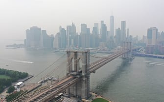 1234079276 NEW YORK, USA -JULY 20: Wildfires burning out of control across the Western United States causes hazy skies throughout New York City and Washington DC July 20, 2021 in New York, United States. According to the National Weather Service, smoke and haze from raging wildfires out west and in Canada that drifted across the Great Lakes region reached the Eastern Seaboard. The experts said the smoke and fog may continue to affect New York. (Photo by Lokman Vural Elibol/Anadolu Agency via Getty Images)
