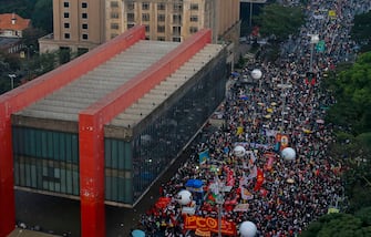 People take part in a demonstration against the Brazilian President Jair Bolsonaro's handling of the COVID-19 pandemic in Sao Paulo, Brazil, on July 3, 2021. - Thousands of Brazilians took to the streets Saturday to protest against President Jair Bolsonaro, who faces an investigation over an allegedly corrupt Covid vaccine deal. (Photo by Miguel SCHINCARIOL / AFP) (Photo by MIGUEL SCHINCARIOL/AFP via Getty Images)