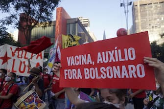 SAO PAULO, BRAZIL - JULY 24: People take part in a demonstration against the Brazilian President Jair Bolsonaro's handling of the coronavirus (COVID-19) pandemic in Sao Paulo, Brazil, on July 24, 2021. - Thousands of Brazilians took to the streets Saturday to protest against President Jair Bolsonaro, who faces an investigation over an allegedly corrupt Covid vaccine deal. (Photo by Cristina Szucinski/Anadolu Agency via Getty Images)