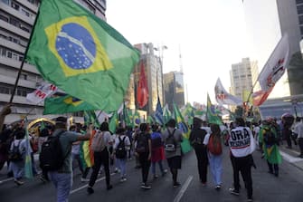 SAO PAULO, BRAZIL - JULY 24: People take part in a demonstration against the Brazilian President Jair Bolsonaro's handling of the coronavirus (COVID-19) pandemic in Sao Paulo, Brazil, on July 24, 2021. - Thousands of Brazilians took to the streets Saturday to protest against President Jair Bolsonaro, who faces an investigation over an allegedly corrupt Covid vaccine deal. (Photo by Cristina Szucinski/Anadolu Agency via Getty Images)