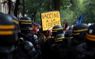 epa09383069 A protester holds a poster reading 'Vaccinated with freedom' during a demonstration against the COVID-19 health pass which grants vaccinated individuals greater ease of access to venues in France, in Paris, France, 31 July 2021. Anti-vaxxers, joined by the anti-government 'yellow vest' movement, are demonstrating across France for the third consecutive week in objection to the health pass, which is now mandatory for people to  visit leisure and cultural venues.  EPA/CHRISTOPHE PETIT TESSON