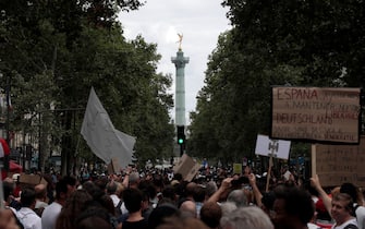 Protestors wave banners and placards as they march during a demonstration, part of a national day of protest against French legislation making a Covid-19 health pass compulsory to visit a cafe, board a plane or travel on an inter-city train, in Paris on July 31, 2021. - The legislation passed by parliament the week before has sparked mass protests in France but the government is determined to press ahead and make the health pass a key part of the fight against Covid-19. A valid health pass is generated by two jabs from a recognised vaccine, a negative coronavirus test or a recent recovery from infection. The legislation also makes vaccination compulsory for health-workers and carers. The pass has already been obligatory from July 21 for visits to museums, cinemas and cultural venues with a capacity of more than 50 people. (Photo by GEOFFROY VAN DER HASSELT / AFP) (Photo by GEOFFROY VAN DER HASSELT/AFP via Getty Images)