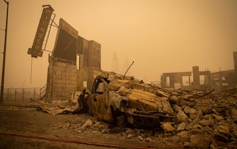 epa09404930 Buildings and vehicles are left destroyed by the Dixie Fire in Greenville, California, USA, 07 August 2021. The Dixie Fire had grown to over 440,000 acres as of 07 August.  EPA/CHRISTIAN MONTERROSA