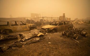 epa09404937 Buildings and vehicles are left destroyed by the Dixie Fire in Greenville, California, USA, 07 August 2021. The Dixie Fire had grown to over 440,000 acres as of 07 August. EPA/CHRISTIAN MONTERROSA
