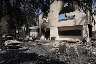 The yard of a burned house following wildfire in Agios Stefanos on the outskirts of Athens, Greece, on Saturday, Aug. 7, 2021. A wildfire north of Athens forced residents to flee their homes during a heatwave in Greece. Photographer: Konstantinos Tsakalidis/Bloomberg via Getty Images