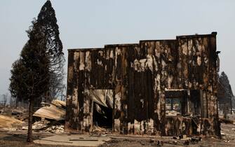 GREENVILLE, CA - AUGUST 08: A burned building remains standing amidst rubble on August 8, 2021 in GREENVILLE, California. Ignited on July 7, 2021 the Dixie Fire has burned 463,477 acres and remains only 21% contained. (Photo by Maranie R. Staab/Getty Images)