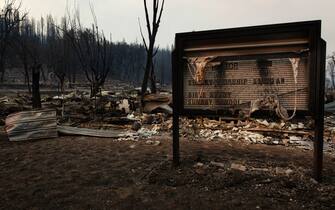 GREENVILLE, CA - AUGUST 08: A church sign is still legible near the burned remains of the church building on August 8, 2021 in GREENVILLE, California. Ignited on July 7, 2021 the Dixie Fire has burned 463,477 acres and remains only 21% contained. (Photo by Maranie R. Staab/Getty Images)