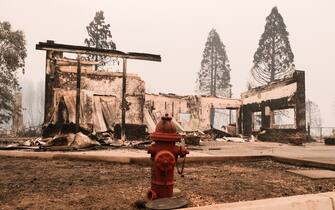 GREENVILLE, CA - AUGUST 08: A red fire hydrant sits in front of the remains of a structure destroyed by the Dixie Fire that is situated along Highway 89 on August 8, 2021 in Greenville, California. The Dixie Fire, which has incinerated more than 463,000 acres, is the second largest recorded wildfire in state history and remains only 21 percent contained. (Photo by David Odisho/Getty Images)