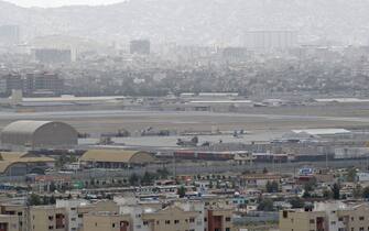 TOPSHOT - This picture taken on August 14, 2021 shows military helicopters standing on the tarmac of military airport in Kabul. (Photo by Wakil KOHSAR / AFP) (Photo by WAKIL KOHSAR/AFP via Getty Images)