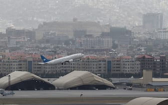 1234671119 This picture taken on August 14, 2021 shows an Ariana Afghan Airlines aircraft taking-off from the airport in Kabul. (Photo by Wakil KOHSAR / AFP) (Photo by WAKIL KOHSAR/AFP via Getty Images)