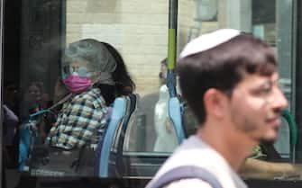 epa09408156  People wear face masks in downtown Jerusalem, 10 August 2021. At least 420,000 Israelis over the age of 60 received a coronavirus booster shot, according to Prime Minister Naftali Bennett, in a measure against the Delta variant, as the country starts to lose its grip on containing the spread of the virus.  EPA/ABIR SULTAN