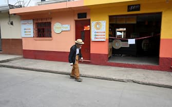 An elderly walks on an empty street during a four day lockdown decreed by local authorities after a spike in the number of COVID-19 cases in San Martin Jilotepeque, Guatemala, on July 9, 2021. - Guatemala has recorded 311,342 cases and 9,609 deaths from COVID-19 as of Thursday, July 8. (Photo by Johan ORDONEZ / AFP) (Photo by JOHAN ORDONEZ/AFP via Getty Images)