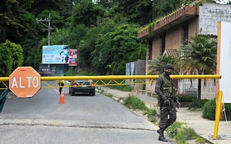 A Guatemalan soldier guards the entrance to San Martin Jilotepeque during a four day lockdown decreed by local authorities after a spike in the number of COVID-19 cases in Guatemala, on July 9, 2021. - Guatemala has recorded 311,342 cases and 9,609 deaths from COVID-19 as of Thursday, July 8. (Photo by Johan ORDONEZ / AFP) (Photo by JOHAN ORDONEZ/AFP via Getty Images)