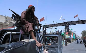A Taliban fighter stands guard atop a vehicle near the site of an Ashura procession which is held to mark the death of Imam Hussein, the grandson of Prophet Mohammad, along a road in Herat on August 19, 2021, amid the Taliban's military takeover of Afghanistan. (Photo by AREF KARIMI / AFP) (Photo by AREF KARIMI/AFP via Getty Images)