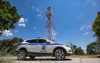 TA police car infront of the new towers equiped with zoom cameras, night vision cameras, thermal cameras and radar are feeding live image to the control room. Greece strengthens its surveillance capabilities to fight the increased refugee and migrants flows from Turkey. The border protection at Greek Turkish borders in Evros region is reinforced, supported by the EU, with more Frontex personnel and vehicles, more Greek border police officers, drones, building a new fence and wall, watchtowers with thermal remote cameras and radar on the tower, new combat vehicles and control rooms. On 20 August 2021 Greek ministers visited Evros to inspect the process of the steel fence works and the border surveillance systems against the new expected migrant crossing as EU is expecting a new asylum seeker wave from people from Afghanistan.  Evros Region, Greece on June 18, 2021 (Photo by Nicolas Economou/NurPhoto via Getty Images)