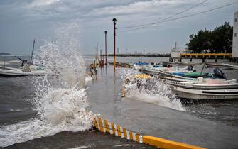 View of strong waves reaching a dock due to Hurricane Grace, which has reached category 2, in Boca del Rio, Veracruz, Mexico, on August 20, 2021. - Grace regained hurricane strength Friday as it barreled towards Mexico for a second time, triggering warnings of flooding and mudslides in mountains on the eastern mainland. (Photo by VICTORIA RAZO / AFP) (Photo by VICTORIA RAZO/AFP via Getty Images)