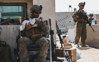 A US soldier calms an infant during an evacuation at Hamid Karzai International Airport, Kabul, Afghanistan, on August 20, 2021, in the days following the fall of Kabul to Taliban movement, amid chaos and panic scenes at the capitalâÂ&#x80;Â&#x99;s airport. Photo by CENTCOM-Balkis Press/ABACAPRESS.COM
