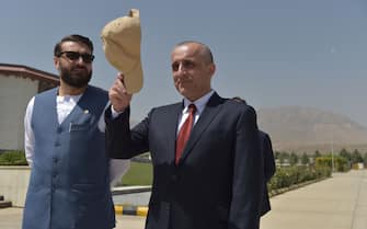 Vice President of Afghanistan Amrullah Saleh (R) gestures holding his cap as he stands along with National Security Adviser of Afghanistan Hamdullah Mohib as they wait for the arrival of Afghanistan's President Ashraf Ghani (not pictured) prior to a meeting at the 
Afghan Parliament house in Kabul on August 2, 2021. (Photo by Wakil KOHSAR / AFP) (Photo by WAKIL KOHSAR/AFP via Getty Images)
