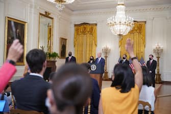 Members of the media raise their hands to ask questions as U.S. President Joe Biden delivers remarks in the East Room of the White House in Washington, D.C., U.S., on Friday, Aug. 20, 2021. Theres mounting evidence the Taliban are cracking down on dissent in Afghanistan and carrying out reprisals, even after its leadership promised an amnesty, adding urgency to global efforts to evacuate those most at risk. Photographer: Al Drago/Bloomberg via Getty Images