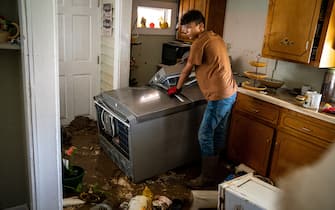 Aug 22, 2021; Waverly, TN, USA; Kalyn Clayton, 16, surveys the damaged kitchen of a home while volunteering with his church youth group in Waverly, Tenn., Sunday, Aug. 22, 2021. 15 inches of rainfall caused substantial flooding in the Humphreys County city, with the death toll at 15 and 40 others still missing as of Sunday morning.Mandatory Credit: Andrew Nelles-USA TODAY NETWORK/Sipa USA