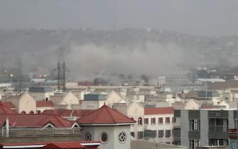 epa09430530 Smoke billows from the airport area after a blast outside the Hamid Karzai International Airport, in Kabul, Afghanistan, 26 August 2021. At least 13 people including children were killed in a blast outside the airport on 26 August. The blast occurred outside the Abbey Gate and follows recent security warnings of attacks ahead of the 31 August deadline for US troops withdrawal.  EPA/AKHTER GULFAM