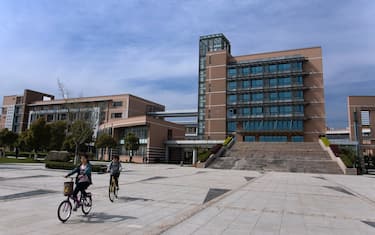 SHANGHAI, CHINA - April 7: Students ride bicycles on the campus of Shanghai University of Engineering Science, in the outskirts on April 7, 2010 in Shanghai, China. (Photo by Lucas Schifres/Getty Images)