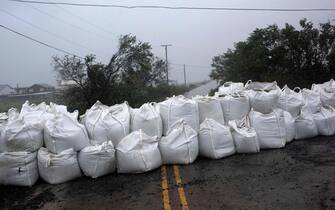 TOPSHOT - Rain comes down at a wall of sandbags in Montegut, Louisiana before Hurricane Ida lands on August 29, 2021. - Hurricane Ida was upgraded to a Category 4 storm as it stayed on course to hit New Orleans with maximum sustained winds reaching 140 miles (225 kilometers) per hour, the US National Hurricane Center said Sunday. Ida was due to make landfall on Sunday, 16 years to the day Hurricane Katrina devastated the southern US city, flooding 80 percent of New Orleans, and leaving behind 1,800 casualties and billions of dollars in damage. (Photo by Mark Felix / AFP) (Photo by MARK FELIX/AFP via Getty Images)