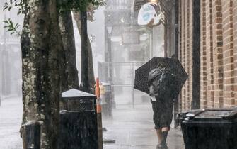 NEW ORLEANS, LOUISIANA - AUGUST 29: A person walks through the French Quarter ahead of Hurricane Ida on August 29, 2021 in New Orleans, Louisiana. Residents of New Orleans continue to prepare as the outer bands of the hurricane begin to cut across the city. Ida is expected to make landfall as a Category 4 storm later today. (Photo by Brandon Bell/Getty Images)