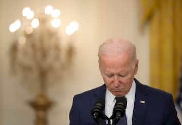 WASHINGTON, DC - AUGUST 26:  U.S. President Joe Biden bows his head in a moment of silence as he speaks about the situation in Kabul, Afghanistan from the East Room of the White House on August 26, 2021 in Washington, DC. At least 12 American service members were killed on Thursday by suicide bomb attacks near the Hamid Karzai International Airport in Kabul, Afghanistan. (Photo by Drew Angerer/Getty Images)